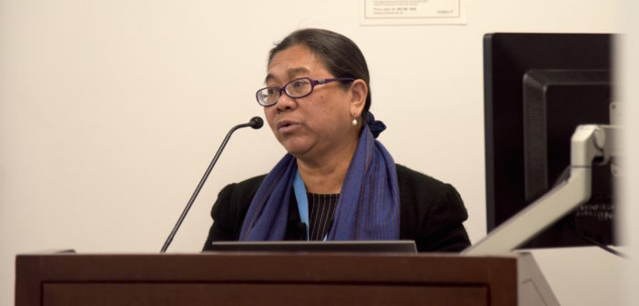 Cecilia Jimenez-Damary addresses her audience at the podium.