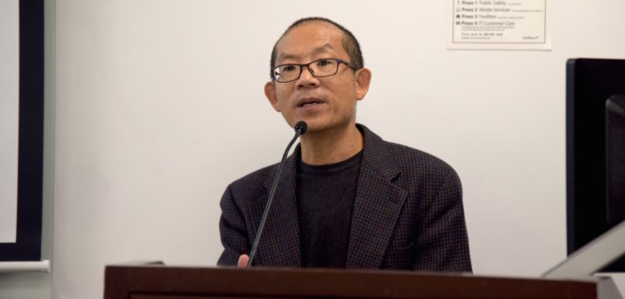 Eric Chen addresses the audience at the podium.