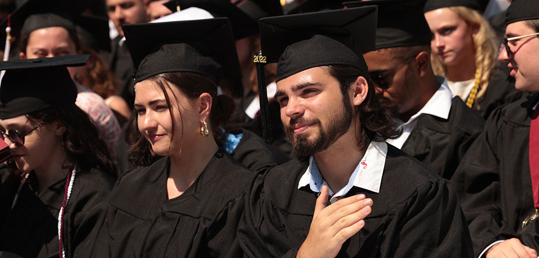 Grad with hand over heart