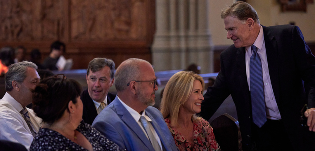 Man leaning over to talk to family