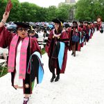 Women graduates processing and cheering